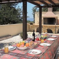08 Rosaria shaded dining and barbeque terrace with a glimpse of the sea.